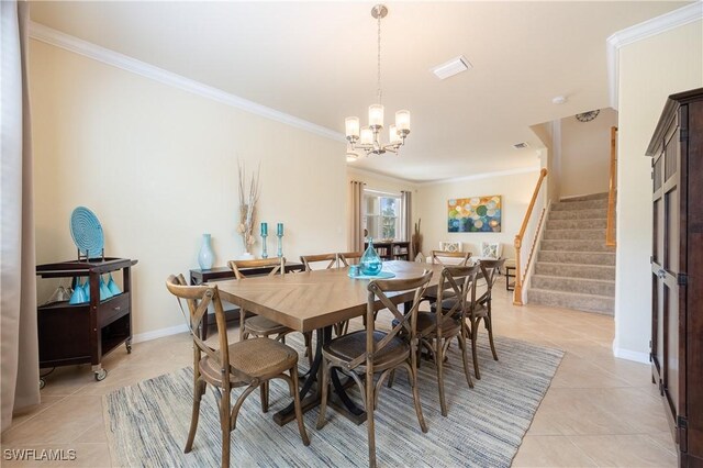 tiled dining room with a chandelier and ornamental molding