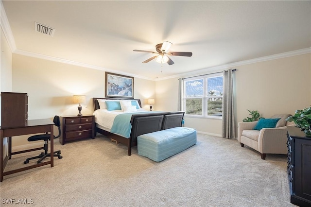 carpeted bedroom with ceiling fan and ornamental molding