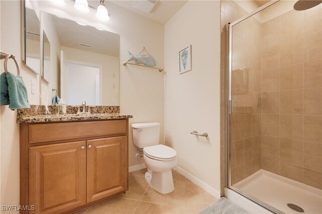 bathroom featuring tile patterned flooring, vanity, an enclosed shower, and toilet