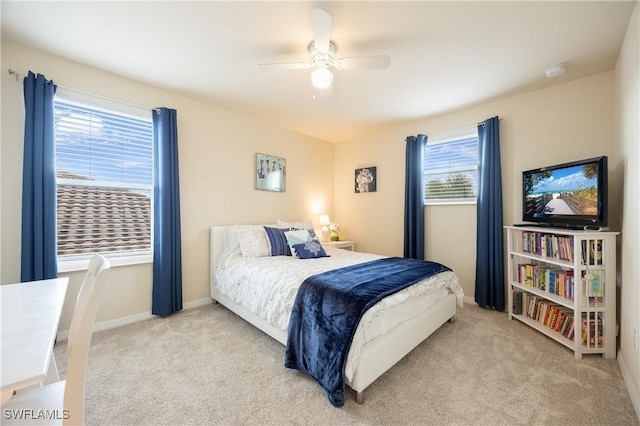 bedroom with ceiling fan and light colored carpet