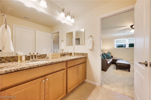 bathroom featuring tile patterned flooring, vanity, ceiling fan, and ornamental molding