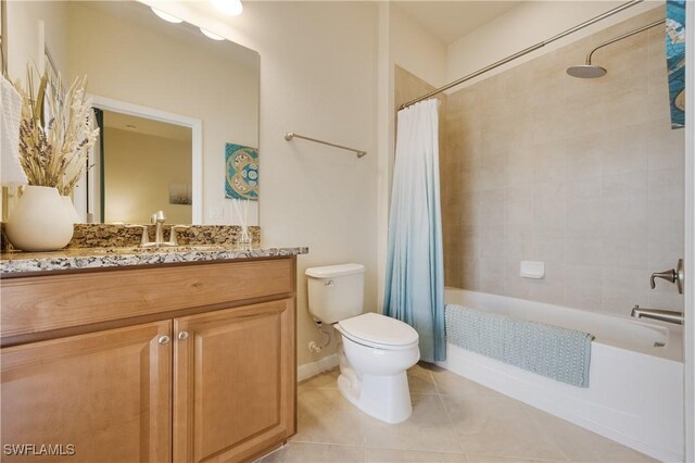 full bathroom featuring tile patterned floors, vanity, toilet, and shower / tub combo with curtain