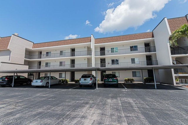 view of property featuring cooling unit and covered parking