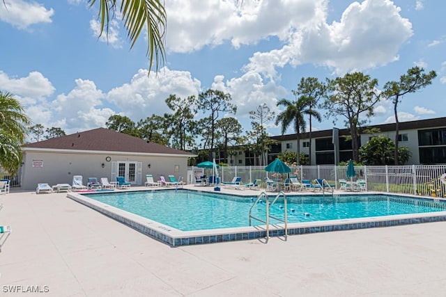 pool featuring a patio area, french doors, and fence