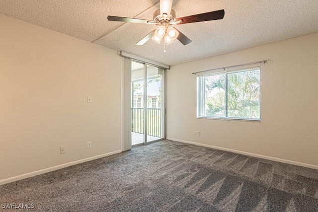 carpeted empty room with baseboards, a textured ceiling, and a ceiling fan