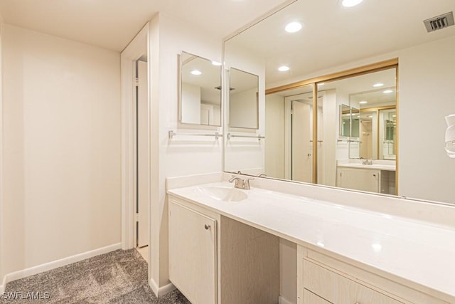 bathroom featuring recessed lighting, vanity, visible vents, and baseboards