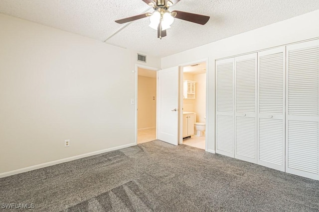 unfurnished bedroom featuring visible vents, baseboards, a closet, a textured ceiling, and carpet floors