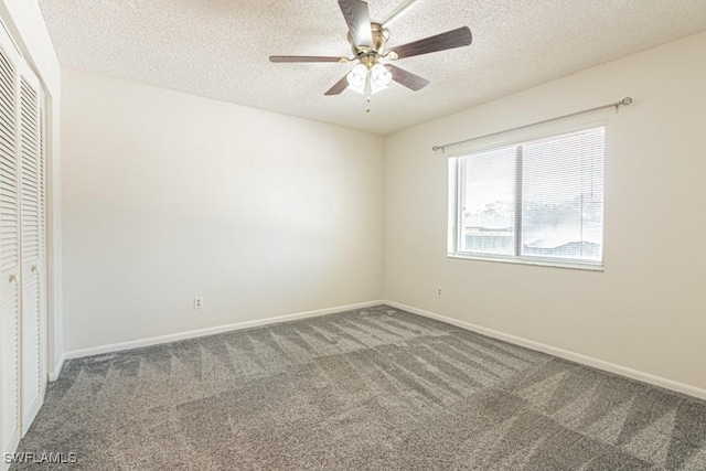unfurnished bedroom with a closet, carpet, a textured ceiling, and baseboards