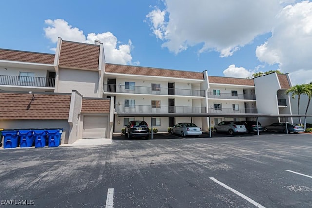 view of building exterior featuring covered parking