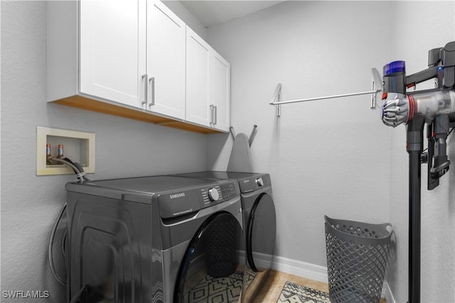 washroom with cabinets and separate washer and dryer