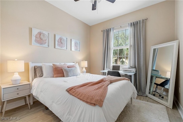 bedroom featuring lofted ceiling, light wood-type flooring, and ceiling fan