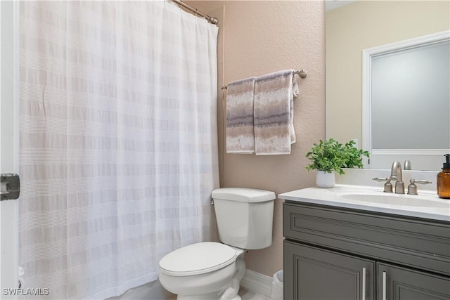 bathroom with a shower with curtain, vanity, and toilet