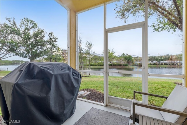 sunroom / solarium with a water view