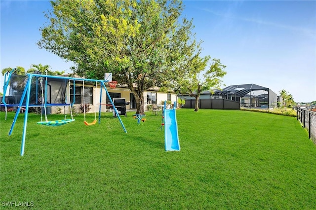 surrounding community with a lawn, a trampoline, and a playground