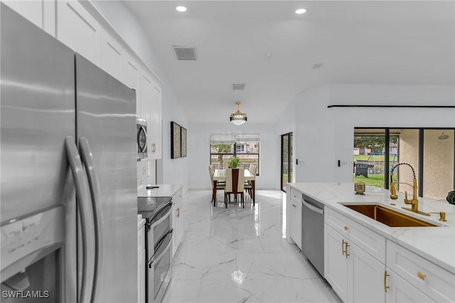 kitchen with white cabinets, plenty of natural light, sink, and appliances with stainless steel finishes