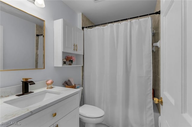 bathroom featuring vanity, curtained shower, and toilet