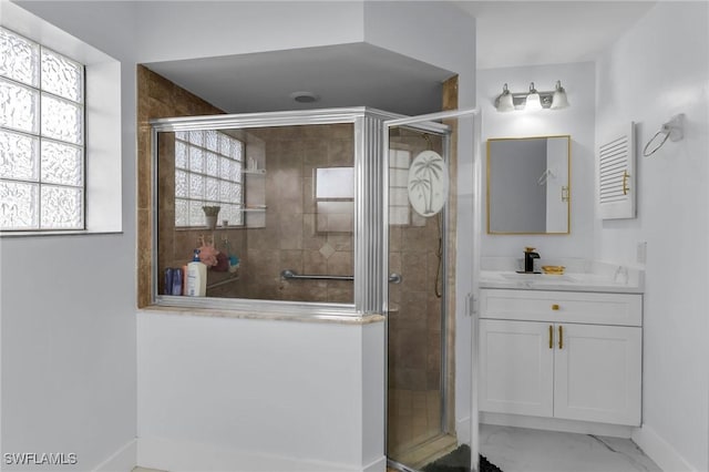 bathroom featuring vanity and a shower with shower door