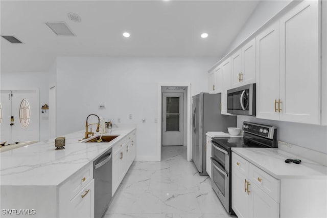 kitchen featuring white cabinetry, sink, light stone countertops, and appliances with stainless steel finishes