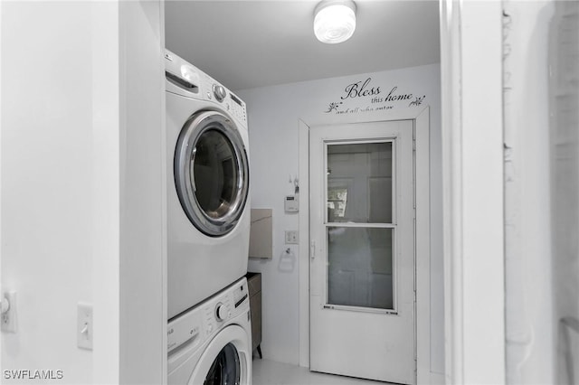 laundry area featuring stacked washer and clothes dryer