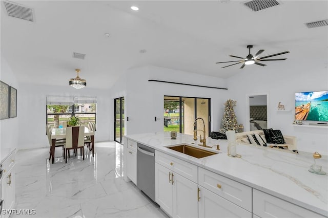 kitchen featuring dishwasher, ceiling fan with notable chandelier, sink, light stone countertops, and white cabinetry