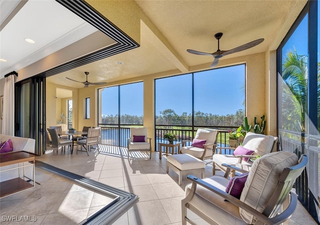 sunroom with a ceiling fan and a healthy amount of sunlight