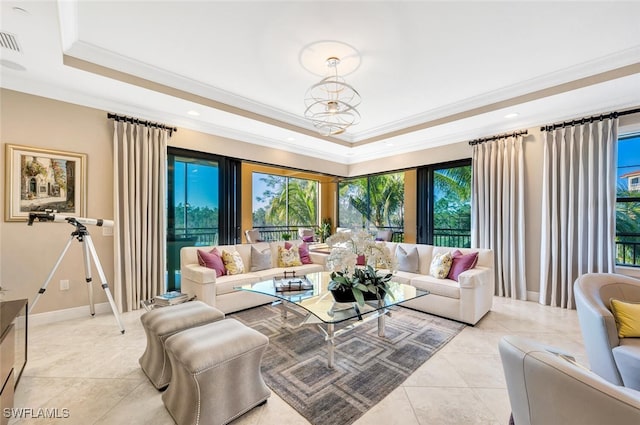 living area featuring light tile patterned floors, baseboards, visible vents, a raised ceiling, and ornamental molding