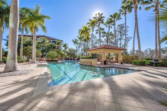 community pool with a patio area and a gazebo