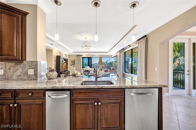 kitchen featuring stainless steel dishwasher, light tile patterned floors, a tray ceiling, and crown molding