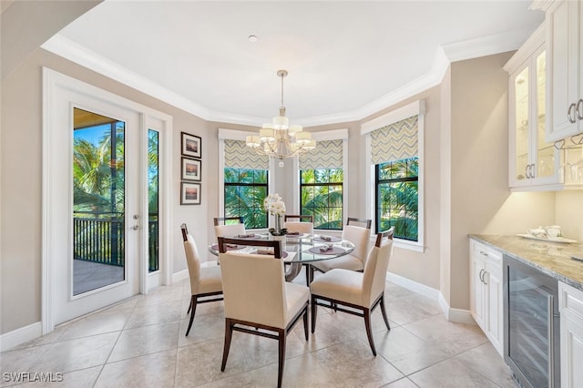 dining room featuring light tile patterned floors, beverage cooler, baseboards, an inviting chandelier, and crown molding