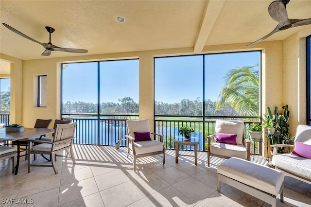 sunroom with a wealth of natural light and a ceiling fan