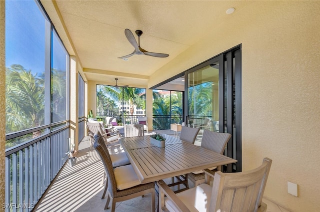 sunroom / solarium with a ceiling fan