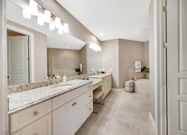 full bath featuring tile patterned flooring, baseboards, a bath, and vanity