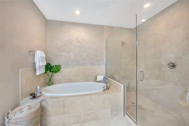 bathroom featuring recessed lighting, a garden tub, and a shower stall