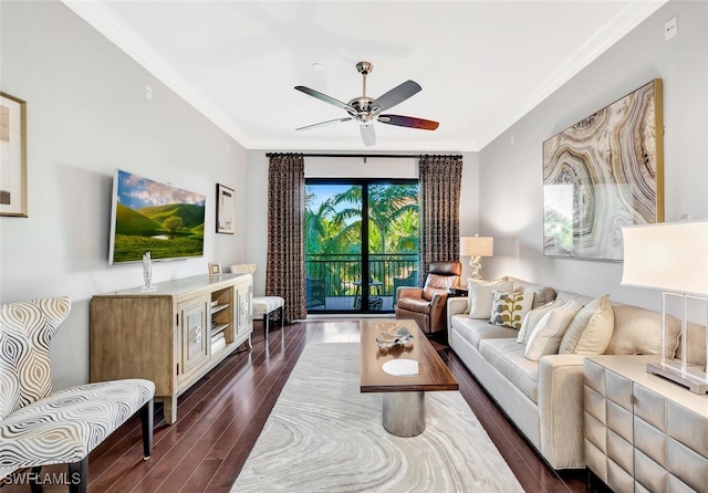 living area with a ceiling fan, dark wood-type flooring, and crown molding