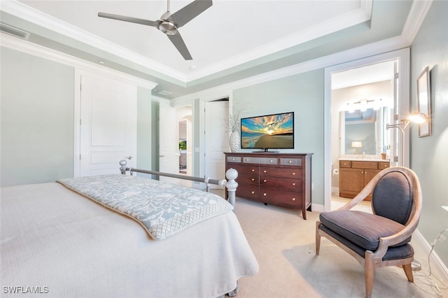 bedroom with light carpet, visible vents, arched walkways, ornamental molding, and a tray ceiling