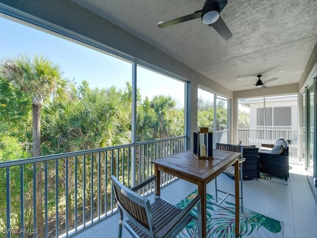 sunroom / solarium featuring ceiling fan