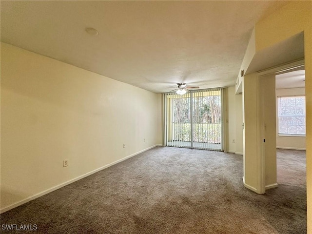 unfurnished room with ceiling fan, a healthy amount of sunlight, and carpet floors