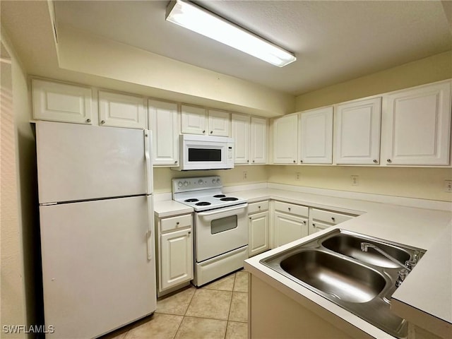 kitchen with white cabinets, white appliances, and sink