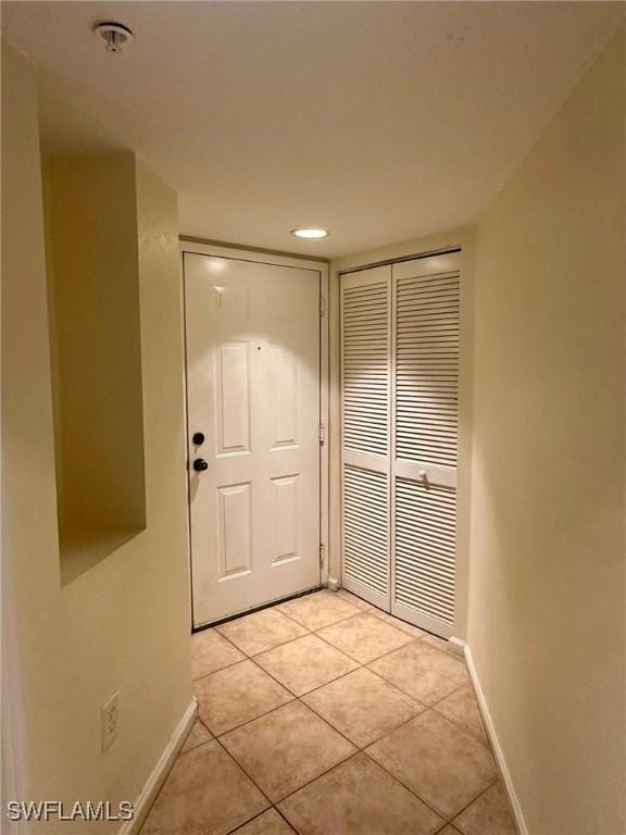 doorway to outside with light tile patterned floors