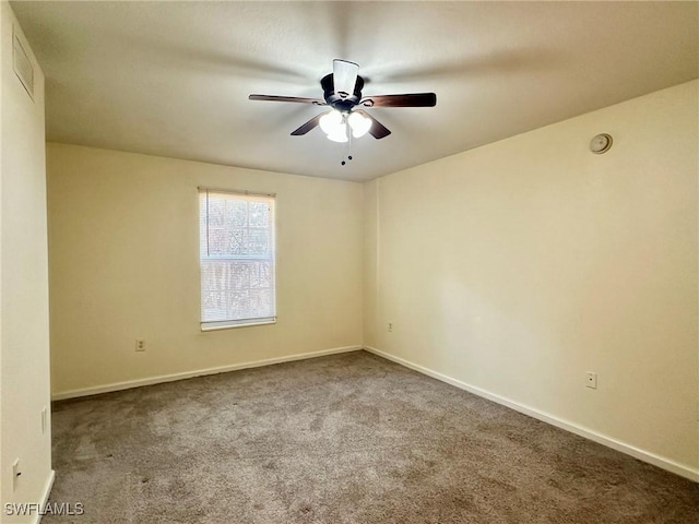 carpeted spare room with ceiling fan