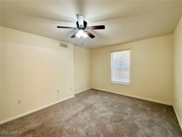 spare room featuring carpet flooring and ceiling fan