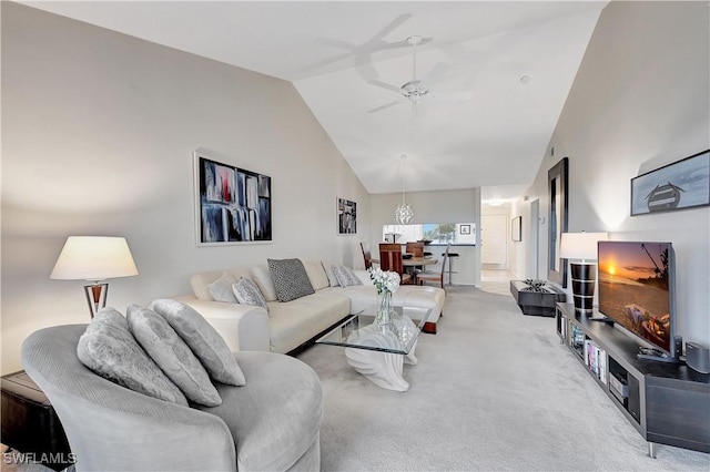 carpeted living room featuring ceiling fan and vaulted ceiling