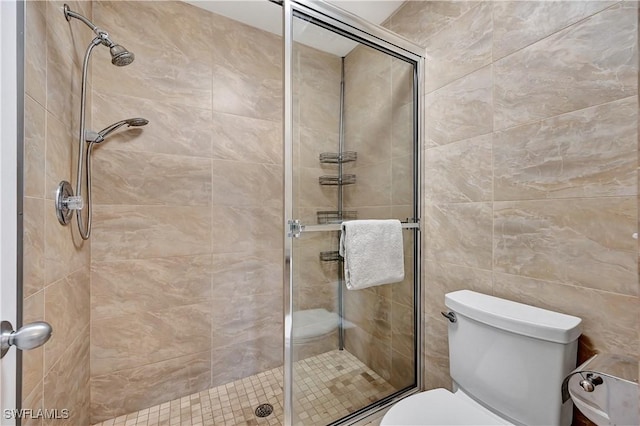 bathroom featuring an enclosed shower and toilet