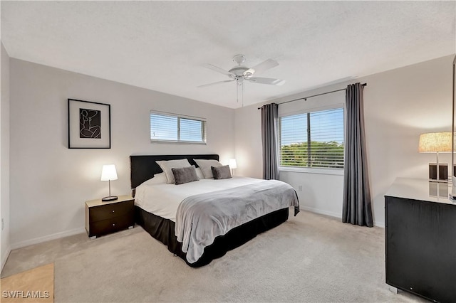 bedroom with light colored carpet and ceiling fan