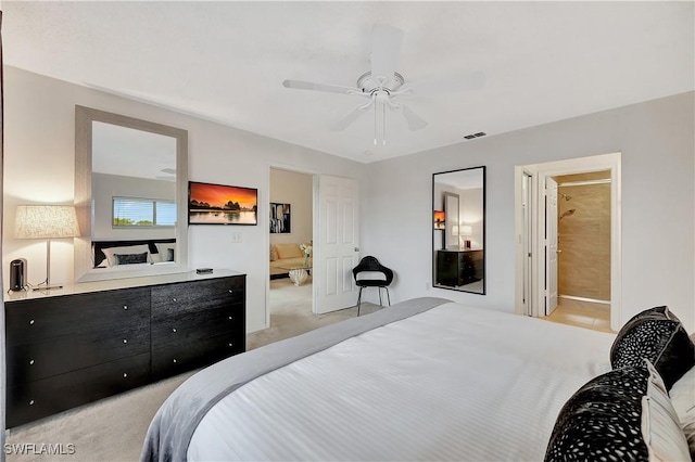 carpeted bedroom featuring ensuite bath and ceiling fan