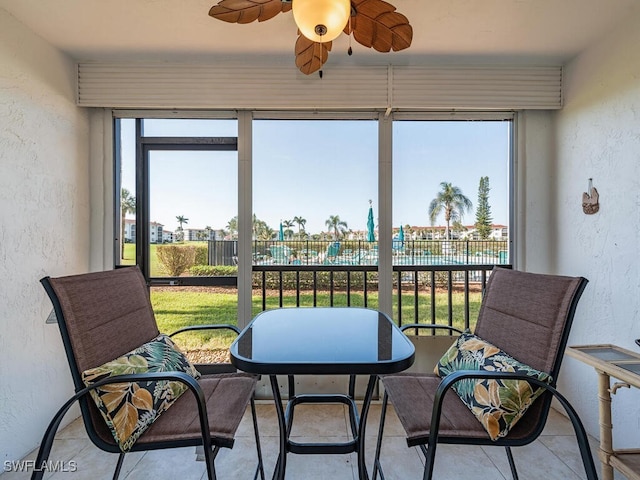 sunroom / solarium featuring ceiling fan