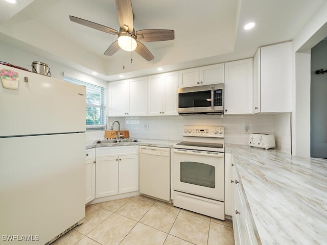 kitchen with sink, white cabinets, white appliances, and light tile patterned floors