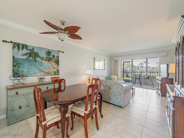 tiled dining room with ceiling fan and crown molding