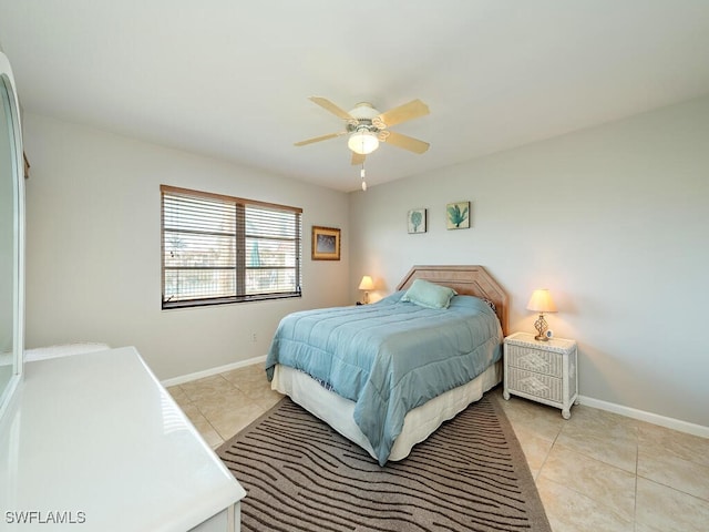 tiled bedroom featuring ceiling fan