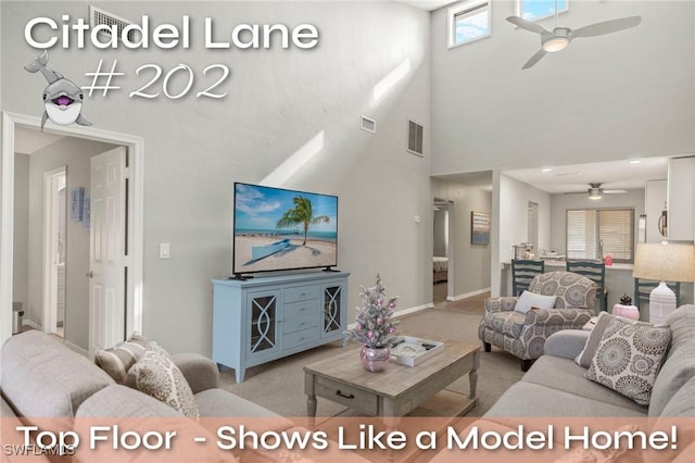 living room featuring ceiling fan, light carpet, and high vaulted ceiling